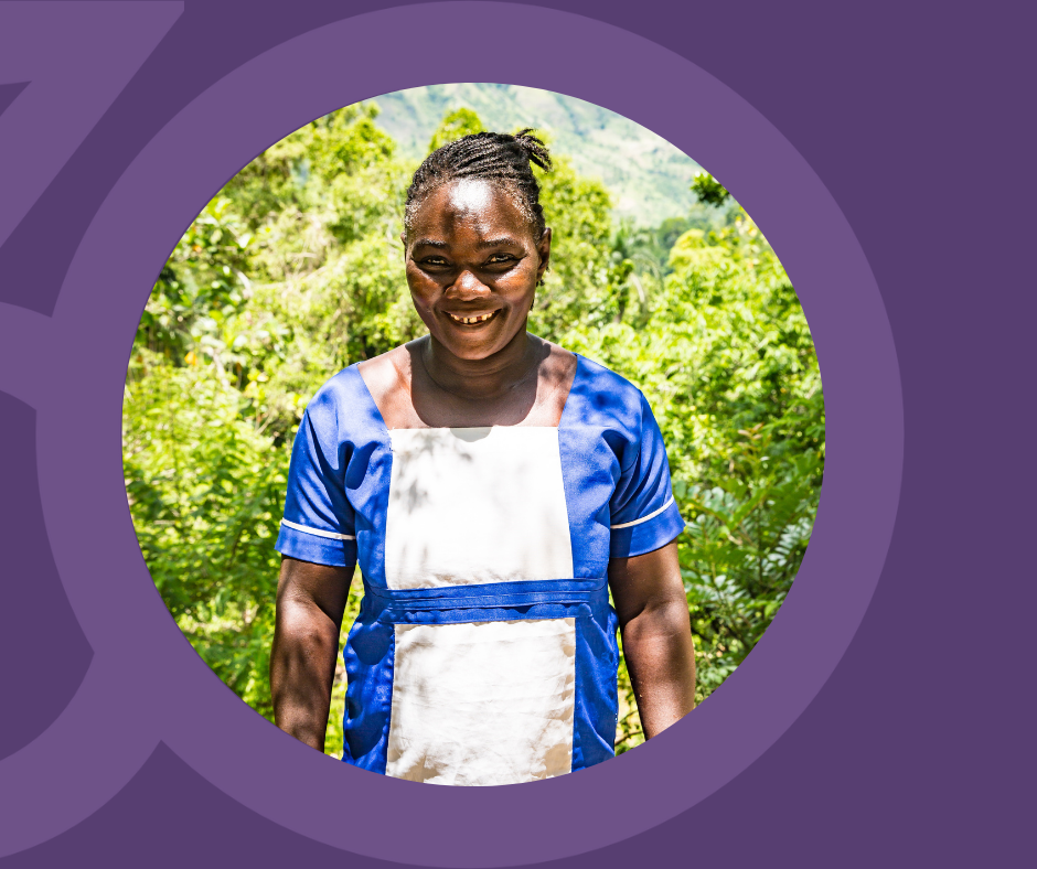 Haitian Woman standing outside with lush landscape.